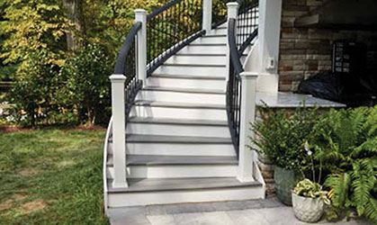 An image of outdoor deck stairs with a railing